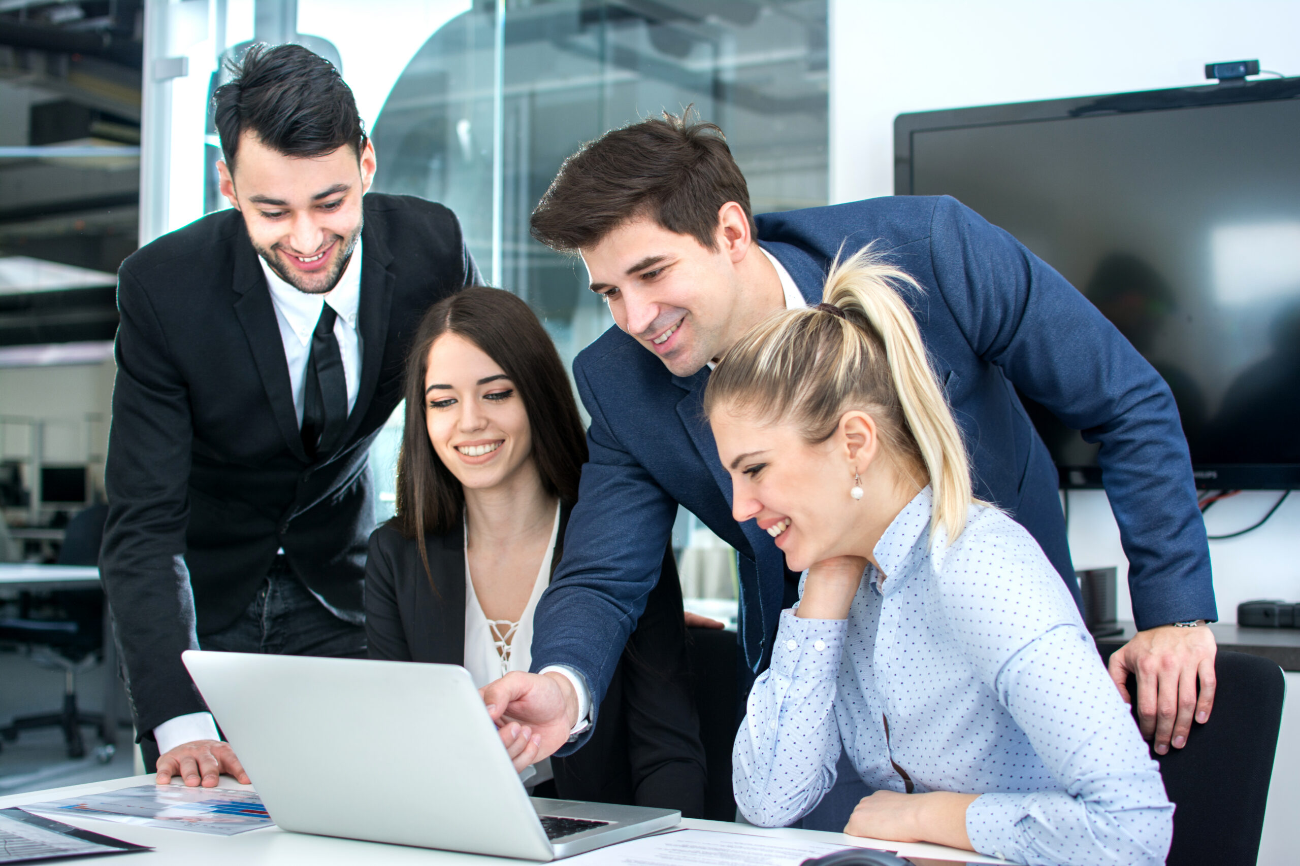 Young business team using laptop together in the office.